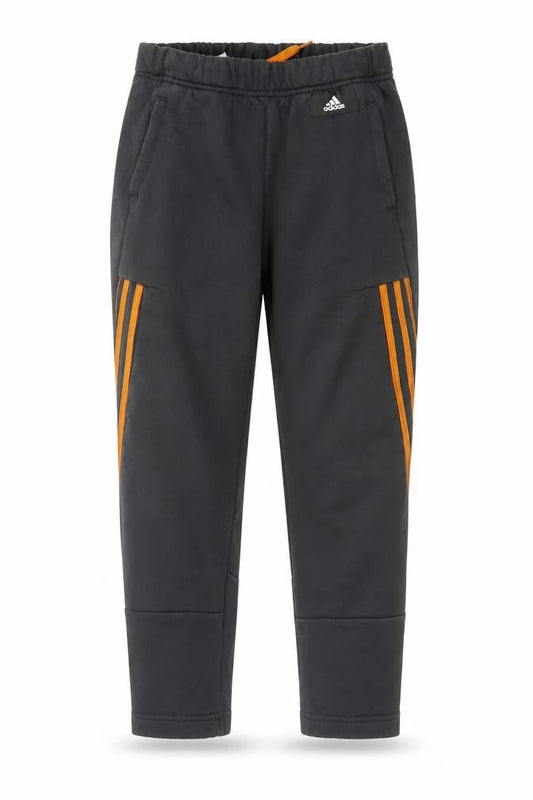 Front view of Adidas boys’ black jogger trousers 11-12 years with orange stripe