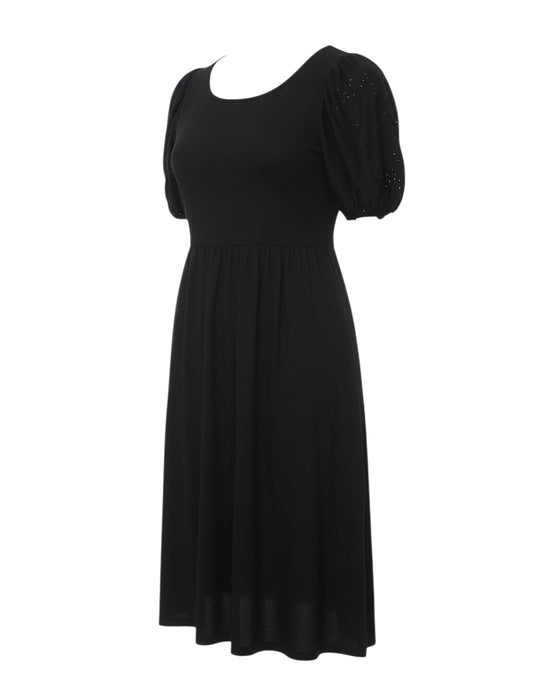 Prewornwholesale black fit and flare knee-length dress with puff sleeves and eyelet detailing on a white background