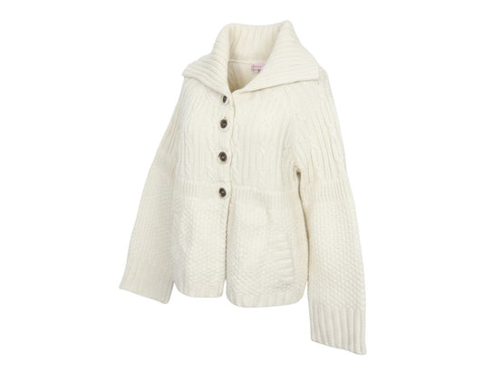 Prewornwholesale ivory cable knit cardigan with a cowl neck, front buttons, and patch pockets in a chunky texture.